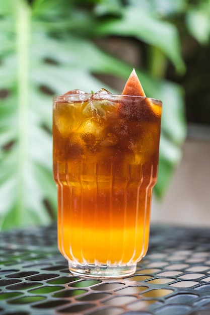 Summer cocktail cold brew coffee or black tea close up selective focus pouring cold drink