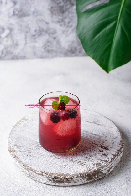 Summer cocktail with blackberry and ice