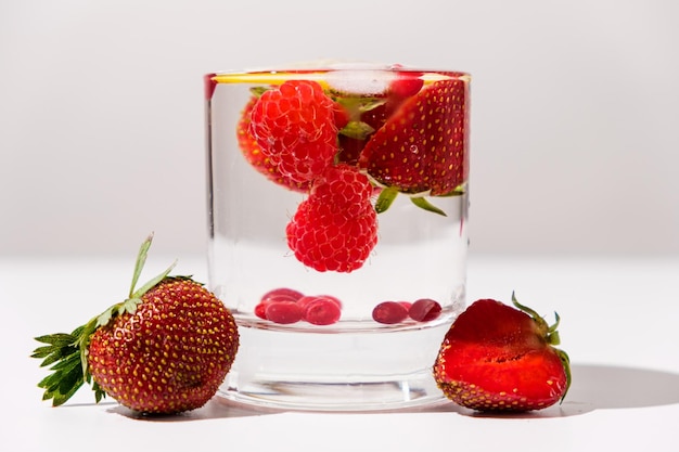 Summer cocktail with strawberries raspberries and ice