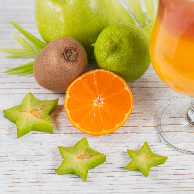 Summer cocktail with various tropical fruits around