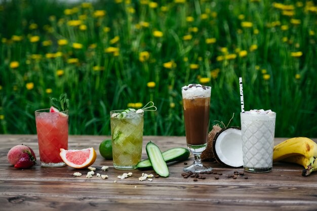 Summer cocktails with fruits on wooden table