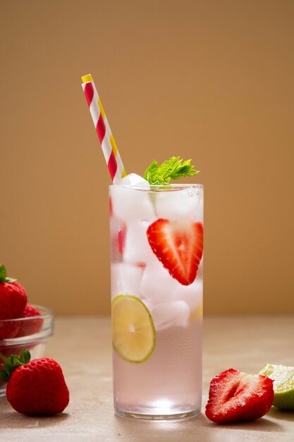 Summer cold refreshing fruit drinks cocktail with strawberry, lime and mint leaves