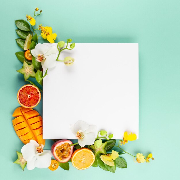 Photo summer composition with fruits and flowers on blue background concept of healthy lifestyle