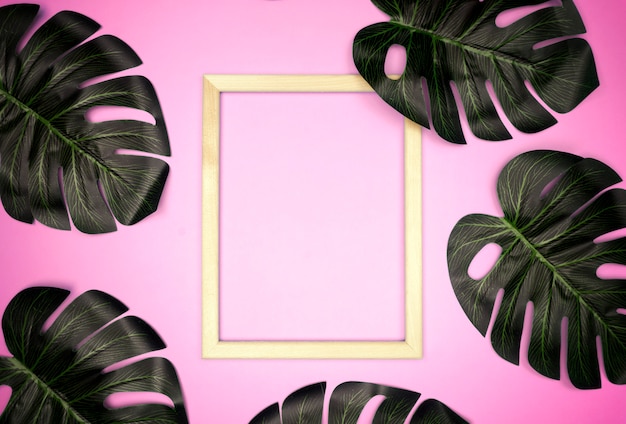 Summer composition with monstera leaves and frame 