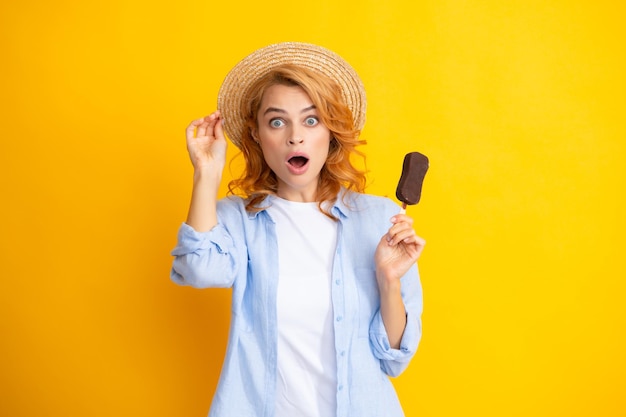 Summer concept Glad positive woman holds tasty frozen ice cream enjoys eating delicious cold dessert poses on yellow background feels happy