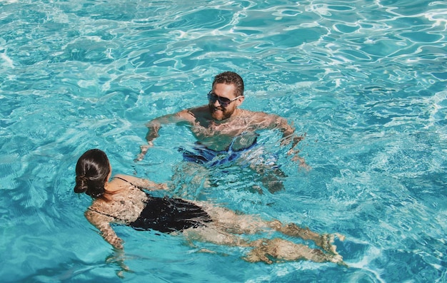 Summer couple in swimming pool pool party spa resort summertime vacation life winner