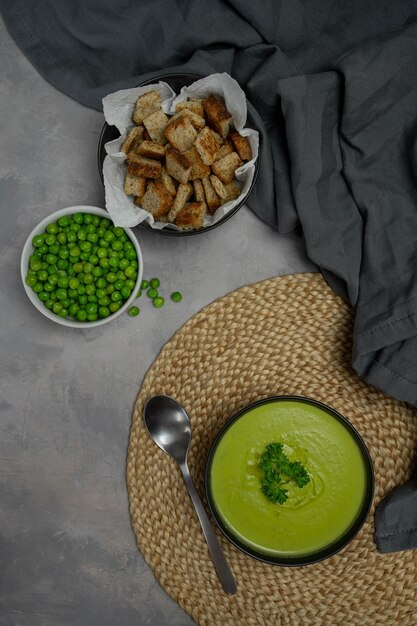 Summer cream soup with green fresh pea shoots top view bio\
food