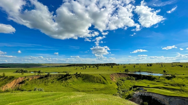 Summer day blue lake on green plains and hills