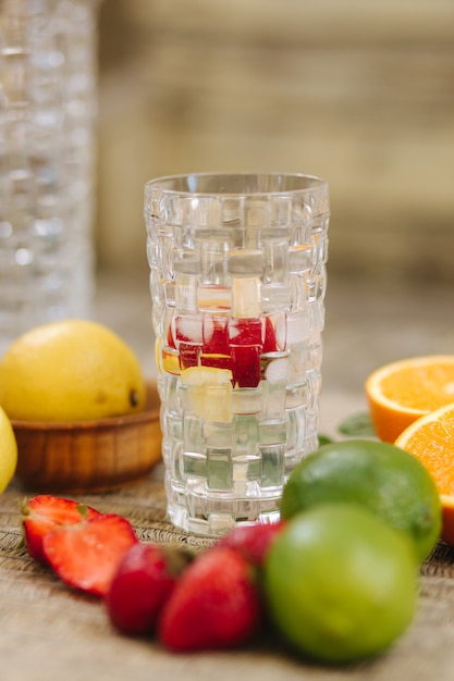 Summer drink citrus lemonade with mint ice and strawberry sliced citrus on table