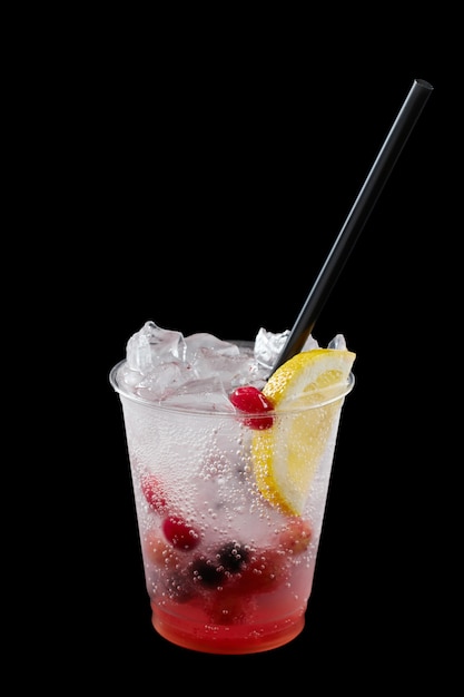 Summer Drink Fresh Lemonade in plastic cup isolated on black background