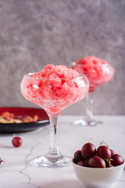 Summer drink frozen wine slushy in glasses on table Refreshing alcoholic cocktail Vertical view