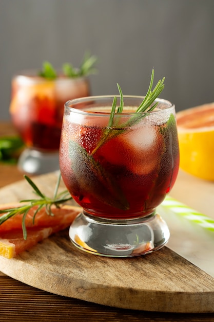 Summer drink. Fruit refreshing cold cocktail. Wooden table.