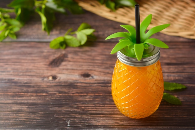 Summer drink, Glass of pineapple juice on wooden table.