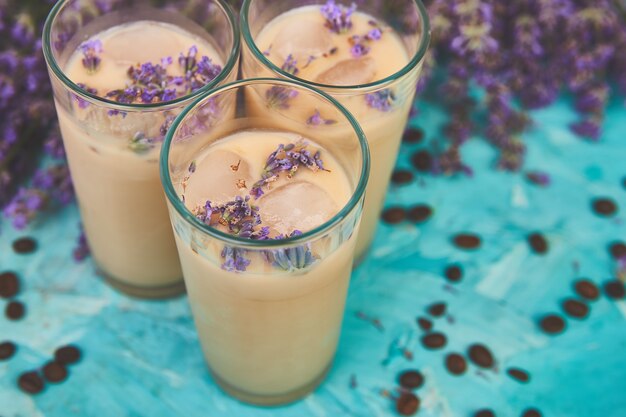 Summer drink iced coffee with lavender in glass