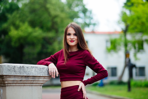 Summer fashion portrait of young beautiful stylish girl posing outdoors