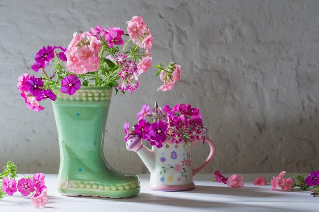 Summer flowers in ceramic boot on white