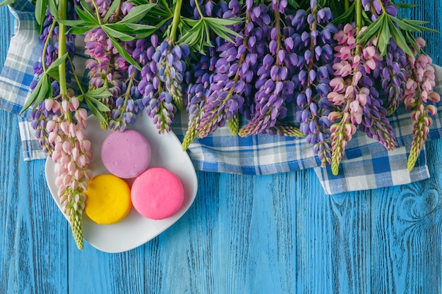 Summer flowers and macaroons on table