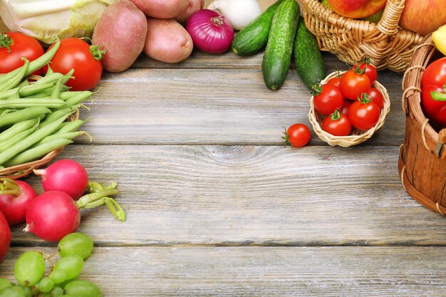 Summer frame with fresh organic vegetables and fruits on wooden background