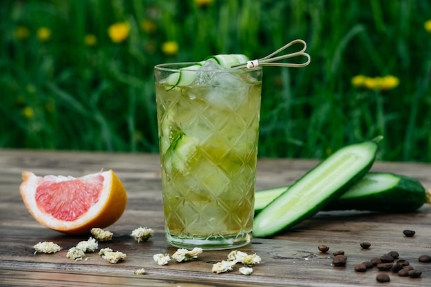 Summer fresh cucumber cocktail on wooden background