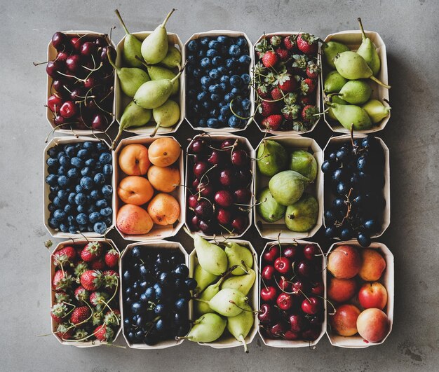 Summer fruit and berry assortment in wooden boxes