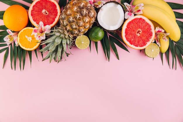 Summer fruit composition on pink table. Flat lay, top view, copy space