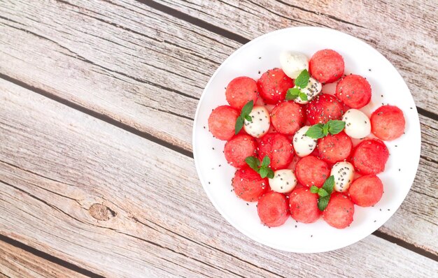 Summer fruit salad with watermelon mozzarella cheese top view