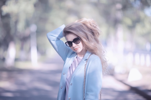 summer girl outdoor air / cheerful adult girl model on a summer walk in the city park, happiness, pleasure freedom