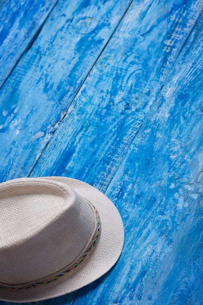 Photo summer hat on the blue wooden table