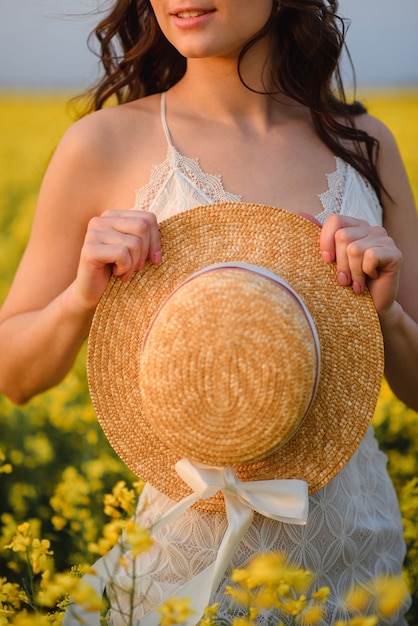 Summer hat in the hands of a woman