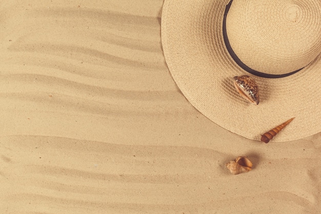 Summer hat put on the tropical sand beach