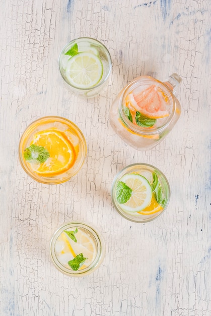 Summer healthy cocktails, set of various citrus infused waters, lemonades or mojitos, with lime lemon orange grapefruit, diet detox beverages