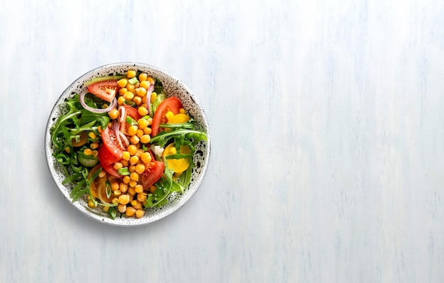 Summer healthy vegetables salad with cucumber chickpeas and tomato Healthy foodTop view