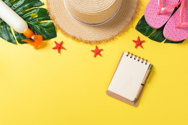 Summer holiday background with beach accessories on colored background top view with copy space