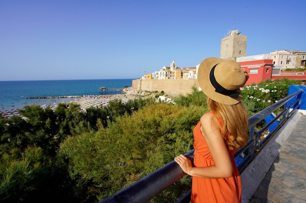 Summer holiday in Italy Attractive young traveler woman visiting Termoli village in Molise region Italy