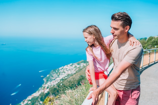 Summer holiday in Italy. Young man and little daughter 