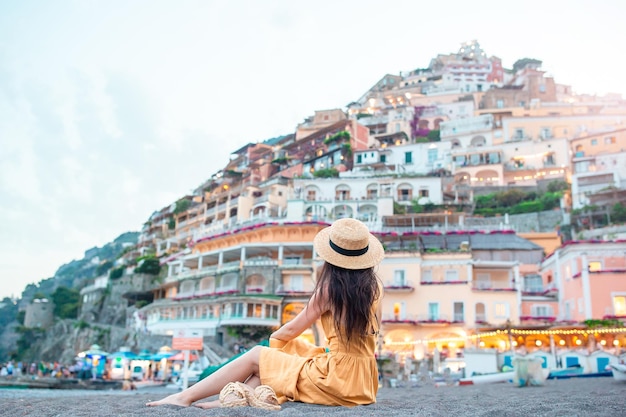 Summer holiday in italy young woman in positano village on the background amalfi coast italy