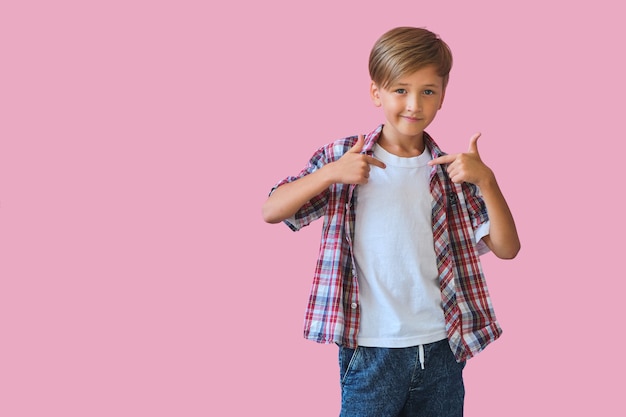 Summer holiday and vacation concept. Happy stylish school boy in yellow sunglasses with thumb up against pink background. Back to school