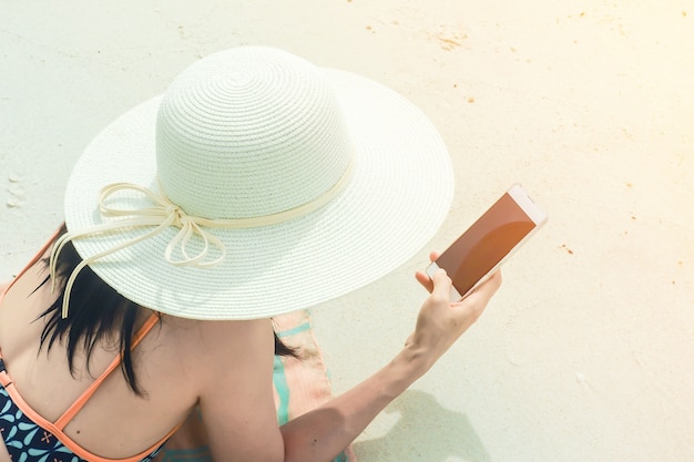 summer holiday women and smartphone on the beach