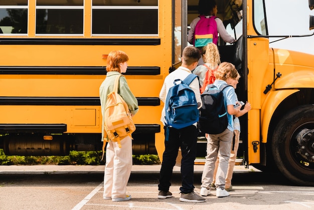 写真 夏休みが終わりました クラスメイトのグループがレッスンに行く前にスクールバスに乗り込み 学校に戻り 列に並んでいます 新学年学期
