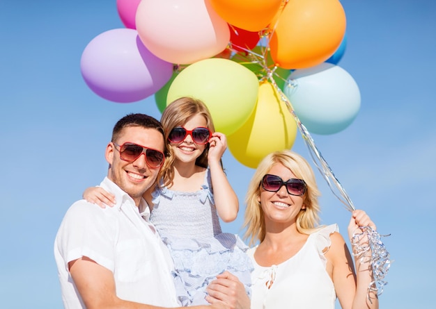 여름 방학, 축하, 어린이 및 사람 개념 - 다채로운 풍선을 가진 가족