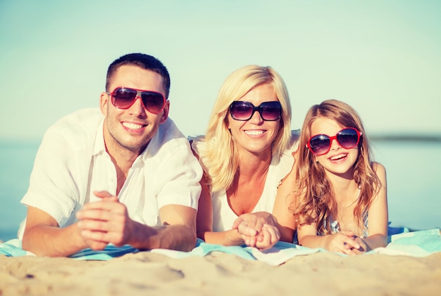 summer holidays, children and people concept - happy family on the beach