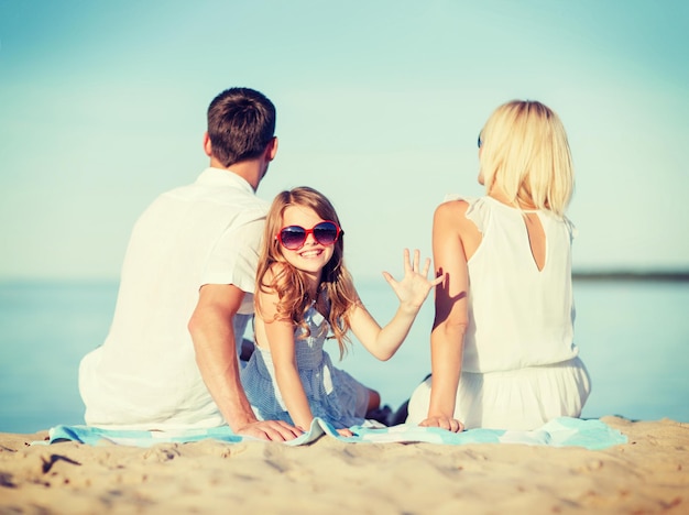 summer holidays, children and people concept - happy family on the beach