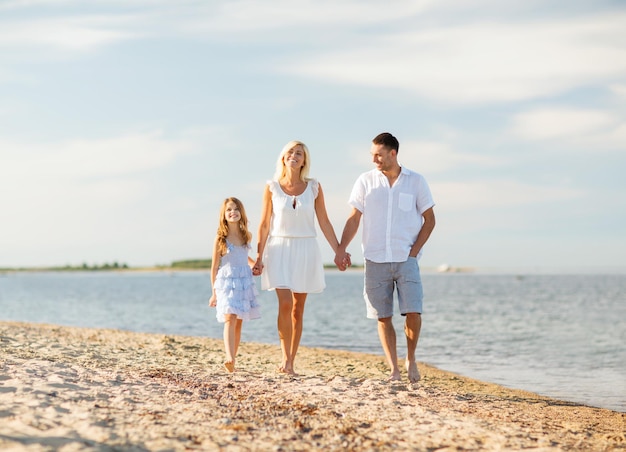 summer holidays, children and people concept - happy family at the seaside