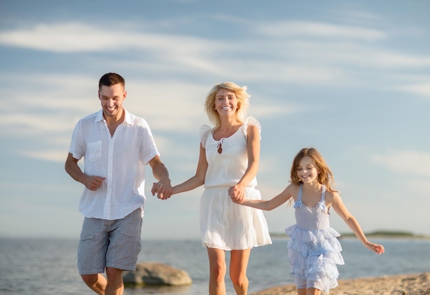 summer holidays, children and people concept - happy family at the seaside