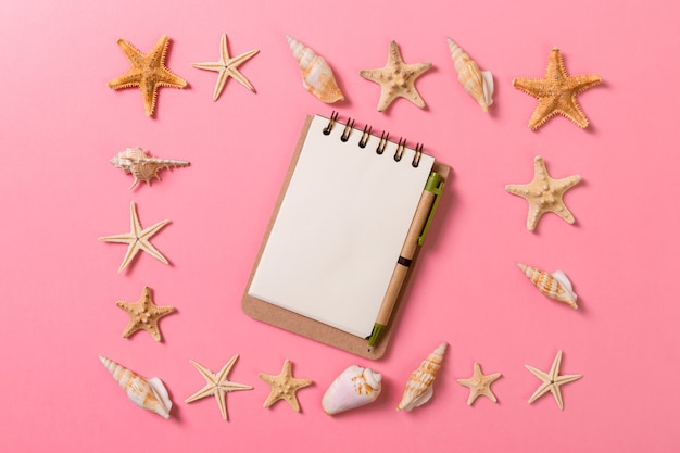 Summer holidays concept. travel background with notepad and starfish . Top view. Flat lay.