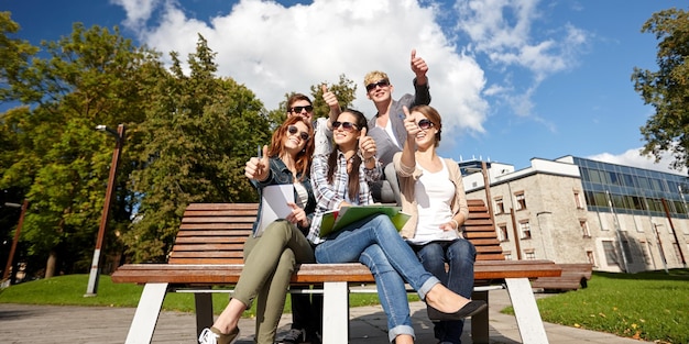 summer holidays, education, campus and teenage concept - group of students or teenagers showing thumbs up