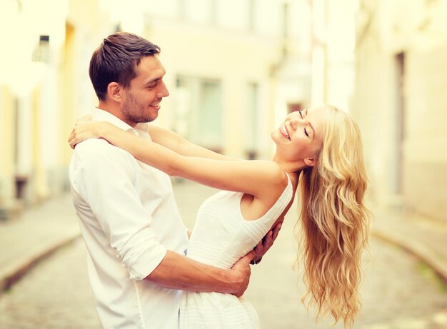 summer holidays, love, relationship and dating concept - smiling couple dancing in the city