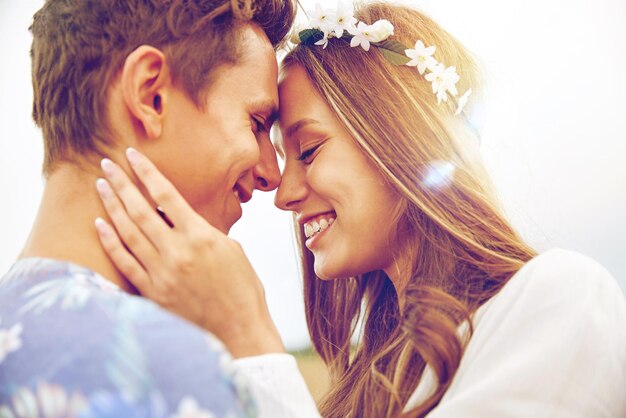 summer holidays, love, romance and people concept - happy smiling young hippie couple hugging outdoors