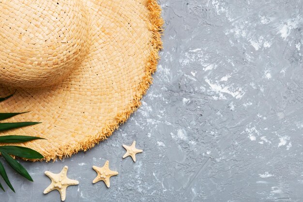 Summer holidays Summer concept with straw hat and tropical leaf Flat lay top view copy space