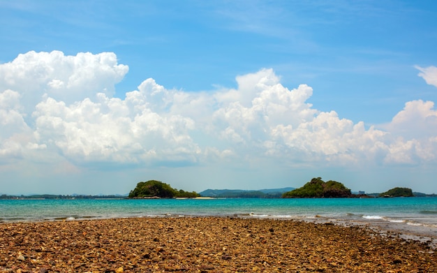 Summer hot sand on beach. Ocean landscape with blue sky. Sunny day and sun light.